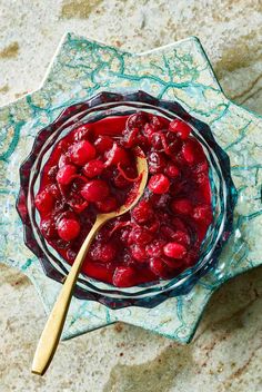 a bowl filled with cranberry sauce on top of a table