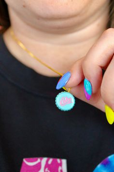 a woman with colorful nail polish holding onto her cell phone