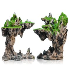 two rocks with moss growing out of them on a white background, one is in the shape of an island