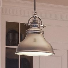 an old fashioned light hanging from the ceiling