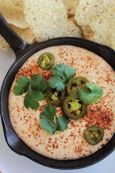 the cast iron skillet has three cheese quesadillas in it and garnished with cilantro