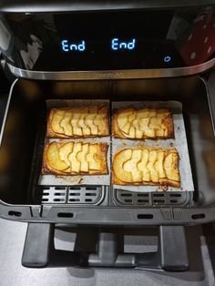 four pieces of bread are being cooked in an electric toaster with the words end end on it