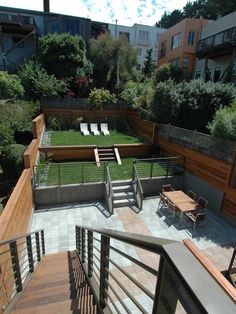 an aerial view of a backyard with wooden steps and seating area on the grass lawn