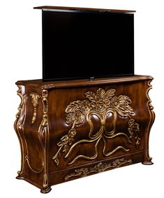 an ornate wooden cabinet with a flat screen tv on top