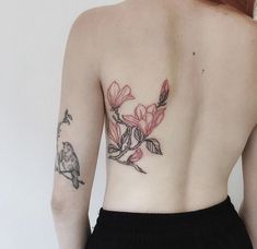 the back of a woman's body with tattoos on her upper and lower half