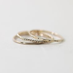 Set of three of our best-selling dainty hammered stacking rings. Set includes (1) smooth stacker, (1) hammered stacker, (1) twist stacker.   Made from 14/20 gold-filled wire, it is water-resistant and will be a piece that lasts. Each piece is custom-made for you, so please allow 1-5 days for the jewelry to ship. - 14/20 gold filled - 1.1mm band - Handmade to order - Comes neatly packaged in a kraft jewelry box ready for gifting Gold Stacking Rings, Gold Minimalist Jewelry, Stacker Rings, Gold Ring Stack, Stackable Rings, Gold Gold, Stacking Rings, Minimalist Jewelry, Cute Jewelry