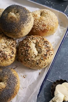 bagels with sesame seeds and butter on a tray