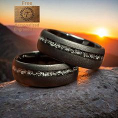 A unique men's wedding ring crafted from black sandblasted tungsten carbide, featuring an inlay of a crushed muonionalusta meteorite, adding a cosmic touch to its design. The interstellar material, formed billions of years ago, offers a profound connection to the vastness of the universe, encapsulated within a symbol of eternal love. Ring Specifications: *Metal: Tungsten Carbide *Inlay: Crushed Muonionalusta Meteorite *Color: Black *Width: 8mm *Fit: Comfort Fit *Size: True to size *Protection: C Mens Wedding Band Black, Mens Wedding Rings Unique, Wedding Band Black, Mens Wedding Ring, Black Tungsten Rings, Wooden Ring Box, Meteorite Ring, Black Tungsten, Tungsten Carbide Rings