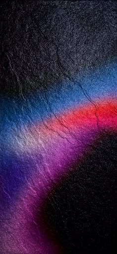 an abstract image of rainbow colors on black background