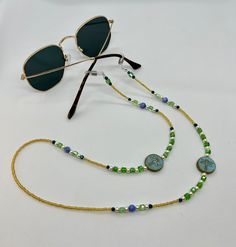 Whether you're headed to a festival, taking a stroll along the beach, or just walking around the block, these sunglass chains are both handy and stylish to bring along for the ride. Convenient if you want to let your glasses hang comfortably on your chest, or put them on to add some flair to any activity you're getting into. Elastic endpieces stretch out and make it easy to slide the chain onto any pair of sunglasses or reading glasses. Each pair is handmade with love in colorful Colorado :) Custom designs are welcome, let me know what you have in mind and I'd love to make it happen! **Photos 3 & 4 are just examples of what they look like on, not necessarily the exact same pair you're looking at. Green Sunglasses For Beach, Summer Blue Glasses Chain With Adjustable Feature, Blue Adjustable Chain Glasses Chains For Summer, Blue Adjustable Glasses Chain For Summer, Trendy Beaded Chain Jewelry For Vacation, Summer Glass Beaded Chain Necklace, Multicolor Glass Sunglasses For Festivals, Summer Festival Necklace With Adjustable Chain, Summer Adjustable Beaded Chain Necklaces