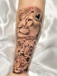 a woman's arm with an image of lions and daisies on the side