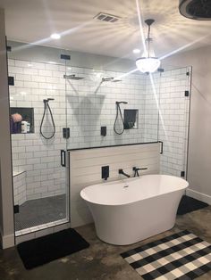 a white bath tub sitting inside of a bathroom next to a walk - in shower