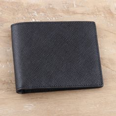 Organize your life with this classy black wallet designed by India's Sanchit. Crafted from 100% leather, the wallet features six bank card slots, one long pocket for bills, and two multipurpose pockets. The inside is lined in ash grey polyester, while the outside leather surface features a cool textured finish. Classic Black Wallet With Coin Pocket, Classic Black Wallet With Smooth Grain, Classic Black Bifold Wallet, Classic Black Trifold Wallet For Business, Classic Black Wallet As Gift, Black Bifold Wallet For Formal Occasions, Formal Black Rfid Blocking Wallets, Black Wallet, Bank Card