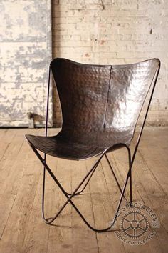 a brown chair sitting on top of a wooden floor