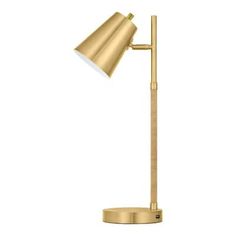 a gold desk lamp on a white background