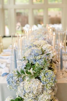 a long table with blue and white flowers on it