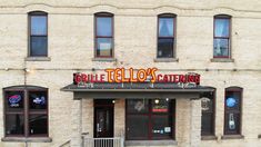 an old brick building with the name tello's catering written on it in large letters