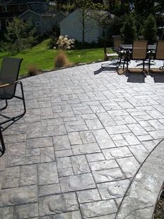 an outdoor patio with chairs and tables