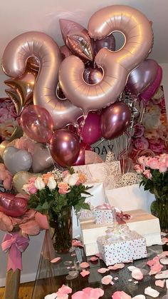 a table topped with lots of balloons and flowers