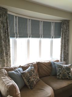 a living room with a couch, window and curtains