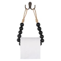 a black beaded necklace hanging from a hook on a white paper towel holder with a blank sign attached to it