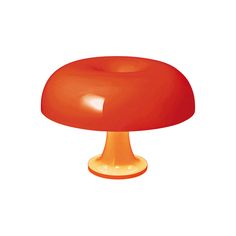 an orange mushroom sitting on top of a white surface