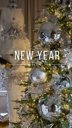 a christmas tree with silver and white ornaments