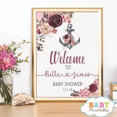 a baby shower sign with flowers and an anchor