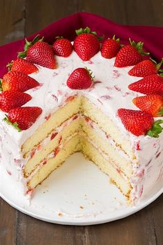 a cake with white frosting and strawberries on top