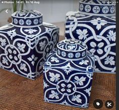 three blue and white vases sitting on top of a table