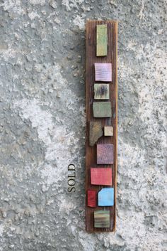 a piece of wood that has been made out of different colored pieces of wood on it