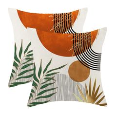 two orange and white pillows with palm leaves on the front, one has an abstract design