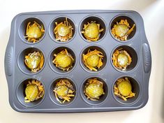 a muffin tin filled with lots of different types of food in it's holes