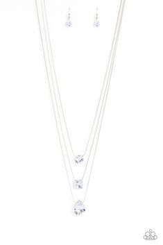 Featuring a subtle iridescent finish, exaggerated, faceted round, square, and teardrop gems layer down the chest from three sleek silver dainty chains, in a refined fashion. Features an adjustable clasp closure. Due to its prismatic palette, color may vary.

Sold as one individual necklace. Includes one pair of matching earrings. Refined Fashion, Layered Necklaces Silver, Jewelry Catalog, Palette Color, Life Of The Party, Paparazzi Accessories, White Necklace, Exclusive Jewelry, Paparazzi Jewelry