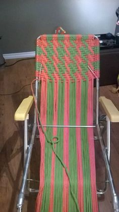 a chair that is sitting on the floor with a piece of yarn attached to it