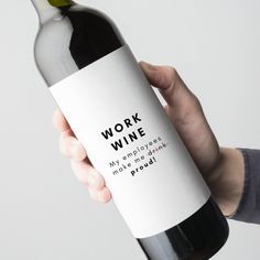 a hand holding a bottle of wine that says work wine my employees make me proud