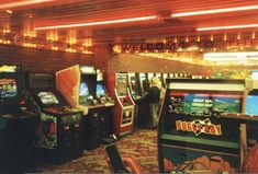 several arcade machines in a room with lights