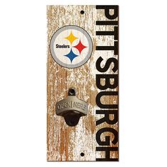 a wooden sign that says pittsburgh with a football logo on the front and back side