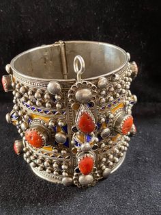 A beautiful authentic antique bracelet of the Beni Yenni, Kabylia, Algeria. Perfect condition. High grade silver, blue and yellow enamel and mediterranean red coral. The bracelet has a weight of 202 grams! Diameter : 6 cm Height : 6,5 cm Traditional Filigree Bracelets For Festivals, Festival Bracelet With Intricate Design, Ornate Silver Bracelets For Festivals, Traditional Ceremonial Filigree Bracelets, Traditional Filigree Bracelets For Ceremonial Use, Vintage Festival Bracelet Jewelry, Vintage Festival Jewelry Bracelet, Ornate Heavy Bracelets For Festivals, Ornate Festival Bracelets