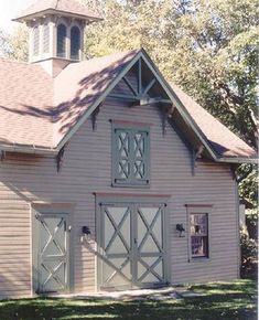 a white barn with a clock tower on top