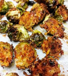 some fried vegetables are sitting on a piece of parchment paper and ready to be eaten