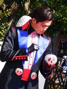 a man dressed in a costume with skulls on his hands