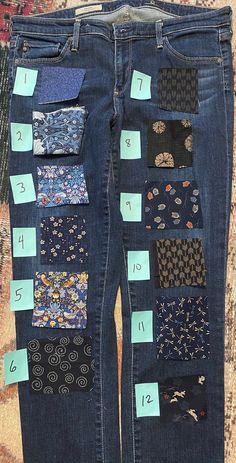 a pair of jeans with patches and numbers on them