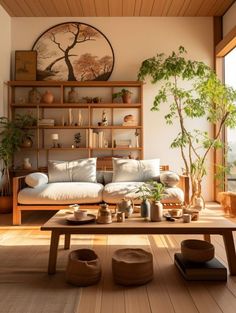 a living room filled with lots of furniture and plants on top of a wooden table