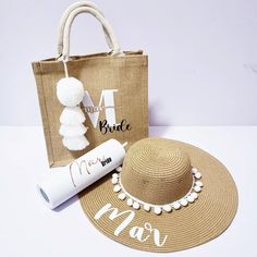 a woman's personalized beach bag, straw hat and tube of sunscreen