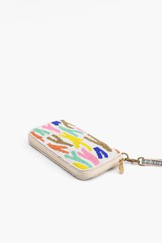 a small wallet with a keychain hanging from it's front pocket, on a white background