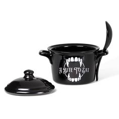 a black pot with a spoon in it and a lid on the side that says, i bite to eat