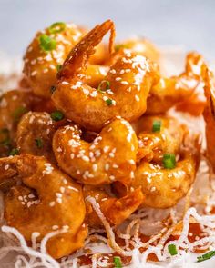 the shrimp is piled high with parmesan cheese and garnished with green onions