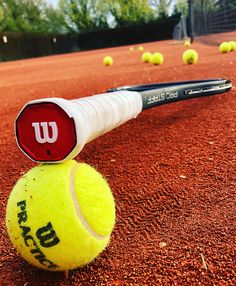 a tennis ball with a racket sticking out of it