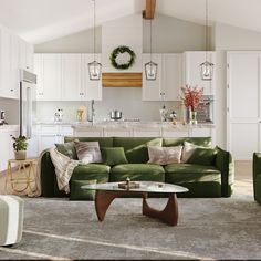 a living room with green couches and white cabinets in the background, surrounded by greenery